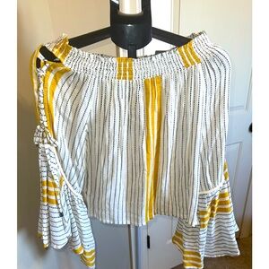 Small, off shoulder, bell arms, with cut outs in sleeve. Like new condition.